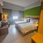 Understated rooms with minifridges in a laid-back hotel featuring a terrace