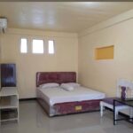 Simply furnished rooms in a utilitarian budget hotel offering Wi-Fi