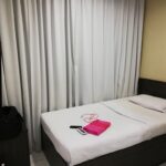 Simple rooms with flat-screens in a casual hotel offering 24/7 room service