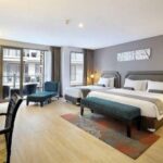 Colorful rooms in an unpretentious hotel featuring an outdoor pool with a bar