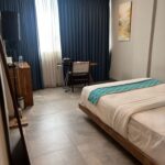 Bright quarters in a casual hotel featuring a rooftop deck with a restaurant