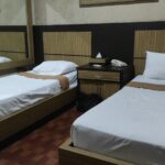 Simple rooms in an unfussy hotel offering 2 outdoor pools