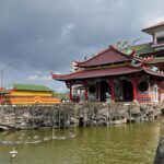 Taoist temple dating back to the 7th century with a large red gate adorned with a giant crab.
