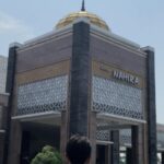 modern mosque with a gold-topped minaret
