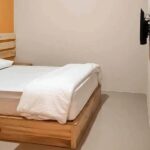 Streamlined rooms with en suite bathrooms in a basic hotel offering Wi-Fi & parking.