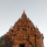 Reconstructed 9th-century Buddhist temple ornately decorated with carved stone reliefs & statues.