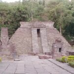 consisting of a pyramid & statues.