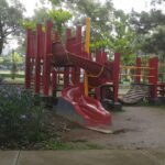 busy park include a playground for children & a stage for events.