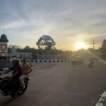 Landmark metal globe adorned with the city's name