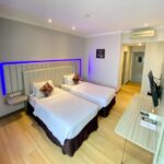 Streamlined rooms with free Wi-Fi in a modern hotel offering an airy