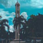 with green & blue tiled domes & a soaring minaret.