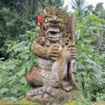 Ancient temple in scenic jungle surrounds with ornate carvings & colorful statues.