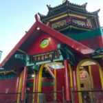 Compact mosque with a distinctive tiered pagoda