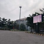 Heart-shaped flower arches & romantic artworks at a park with play areas & colored night lights.
